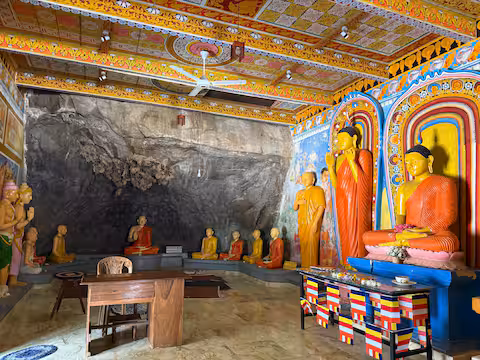 Colourful Buddhist shrine inside a rock temple
