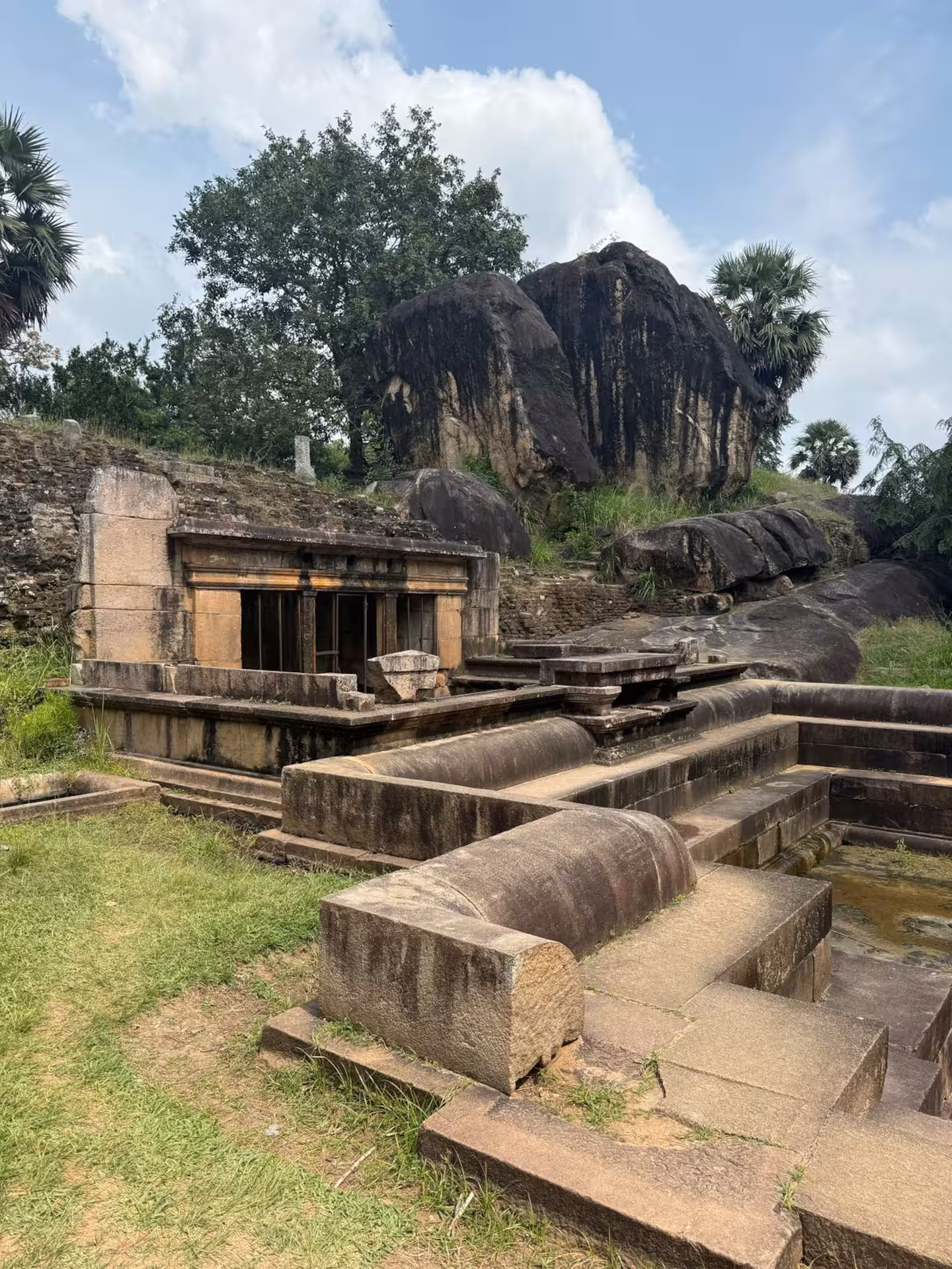 Ancient stone ruins among large boulders